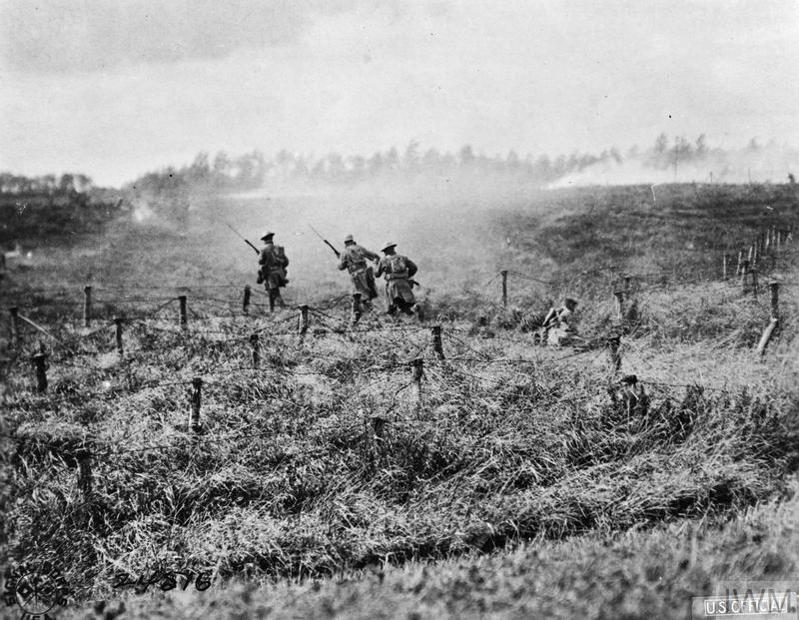 British patrol moving through barbed wire during Hundred Days Offensive.