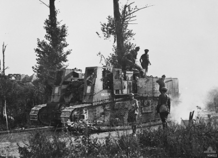 A British Mk1 Gun Carrier Tank advances supported by Infantry during the Second Battle of the Somme